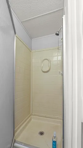 a bathroom with a glass shower door