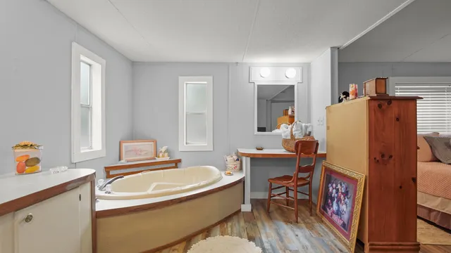 a room that has a sink a chair and a refrigerator