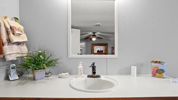 a bathroom with a sink a vanity and a mirror