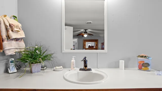 a bathroom with a sink a vanity and a mirror