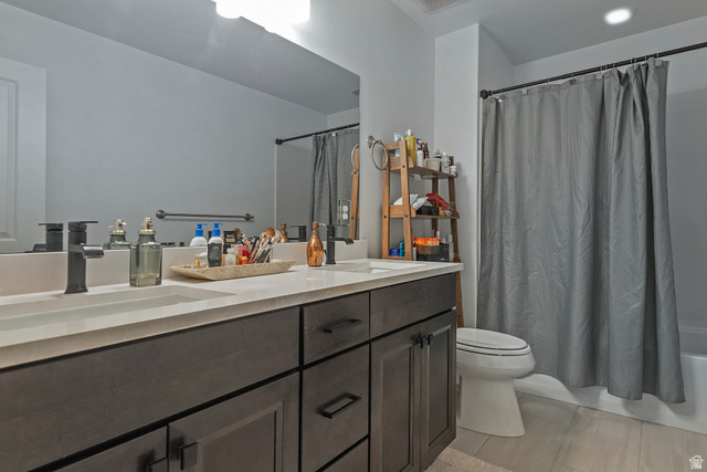 11694 Engelmann Drive Draper, UT 84020 - Photo 29 of 41 Bathroom featuring double vanity and shower / bathtub combination with curtain