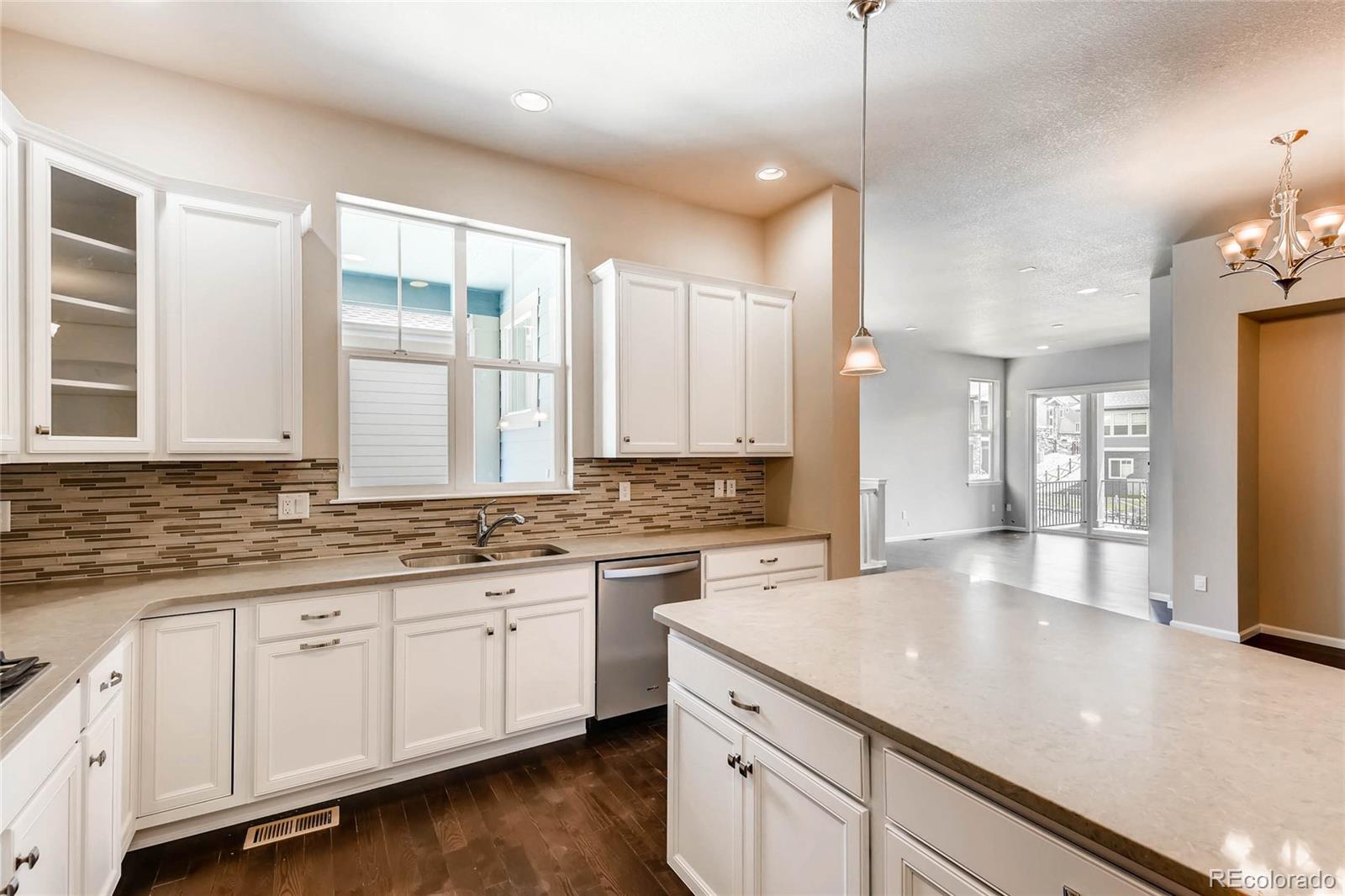 5052 West 109th Circle Westminster, CO 80031 - Photo 13 of 30 a kitchen with a sink stove and cabinets