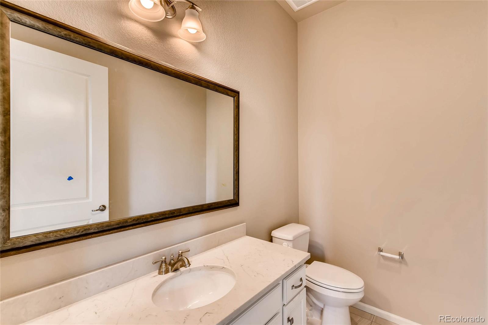 5052 West 109th Circle Westminster, CO 80031 - Photo 14 of 30 a bathroom with a sink and a mirror