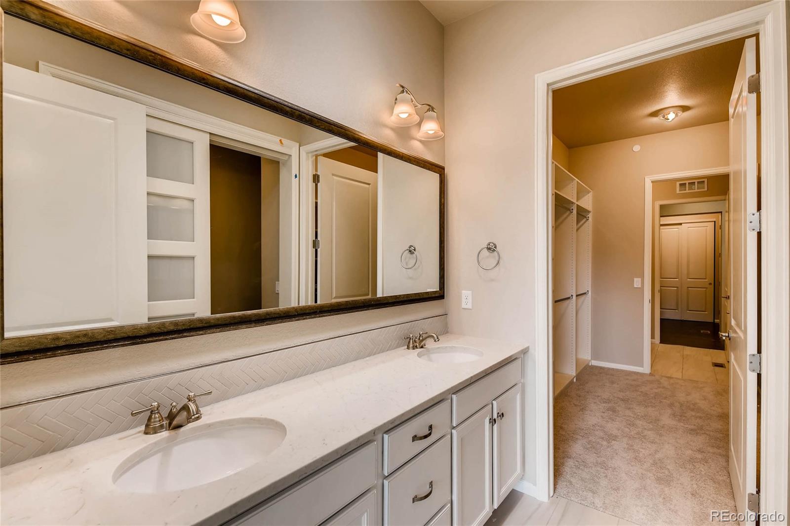 5052 West 109th Circle Westminster, CO 80031 - Photo 17 of 30 a bathroom with a sink and a mirror