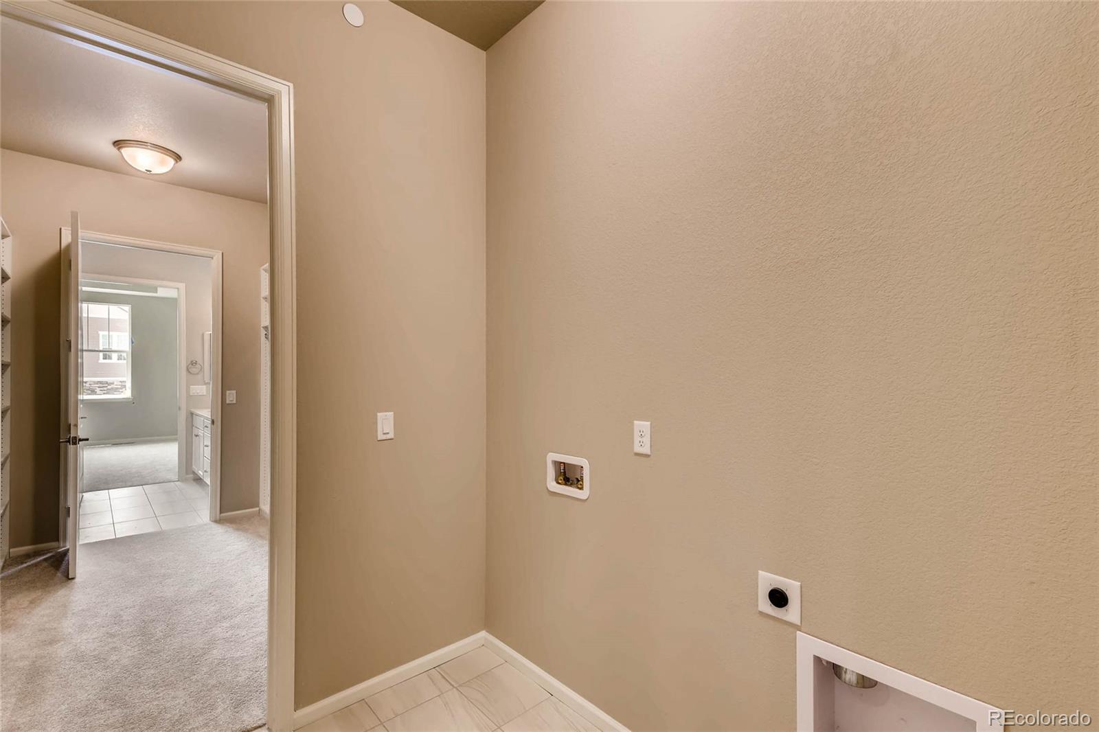 5052 West 109th Circle Westminster, CO 80031 - Photo 25 of 30 a view of a bathroom from a hallway
