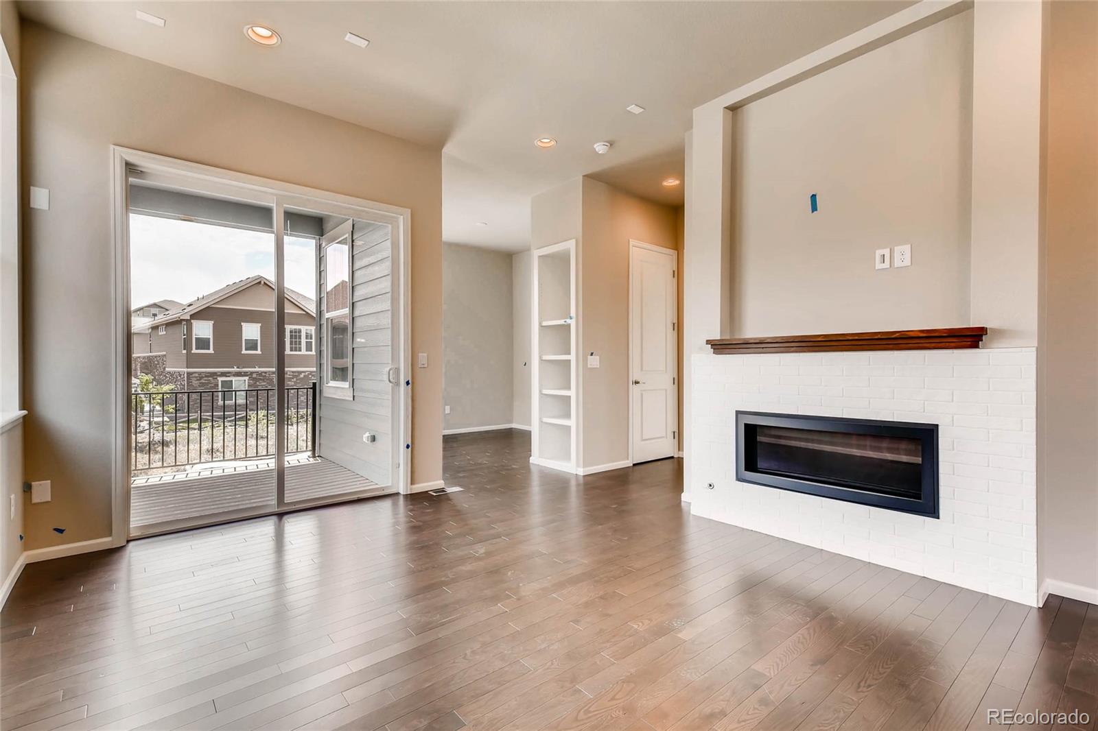 5052 West 109th Circle Westminster, CO 80031 - Photo 4 of 30 a view of a livingroom with wooden floor and fireplace