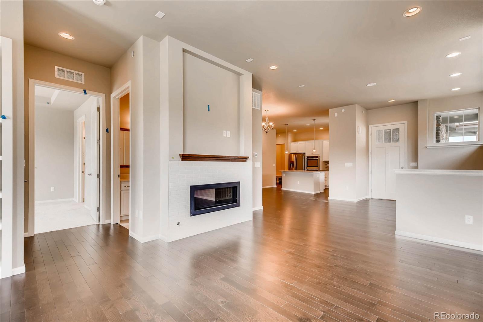 5052 West 109th Circle Westminster, CO 80031 - Photo 5 of 30 a view of a kitchen with a sink and a fireplace