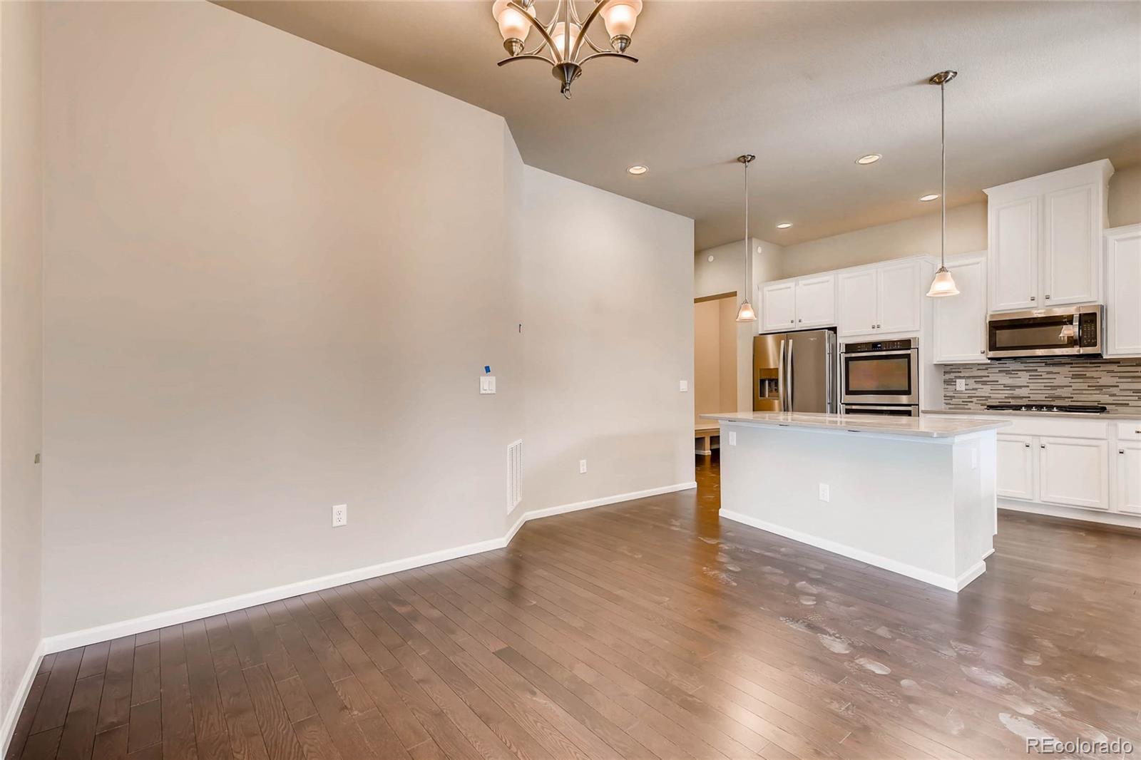 5052 West 109th Circle Westminster, CO 80031 - Photo 7 of 30 a view of kitchen with stainless steel appliances refrigerator and microwave