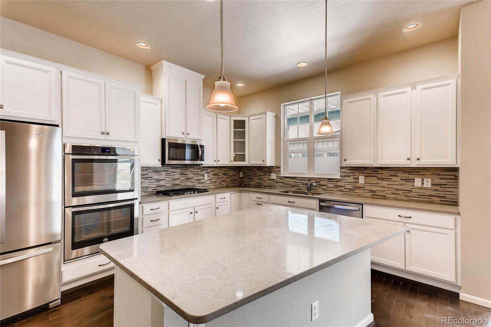 5052 West 109th Circle Westminster, CO 80031 - Photo 9 of 30 a kitchen with granite countertop a sink appliances cabinets and counter space