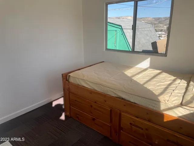 a room with a bed and a window