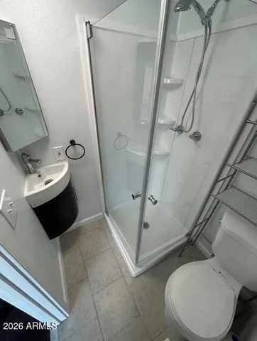 a bathroom with a toilet and a shower
