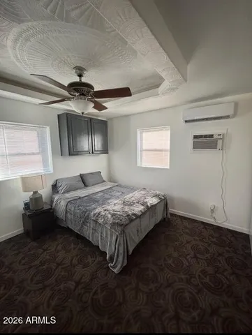 a bedroom with a bed and a ceiling fan