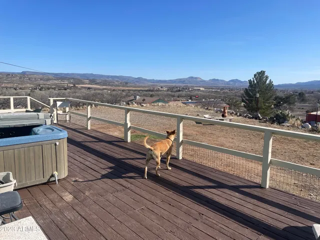 a view of a balcony with wooden floor and city view