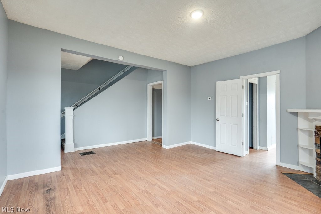 1607 9th Street Southwest Canton, OH 44706 - Photo 10 of 41 Spacious interior room featuring wood-finish flooring, light gray walls, and white trim