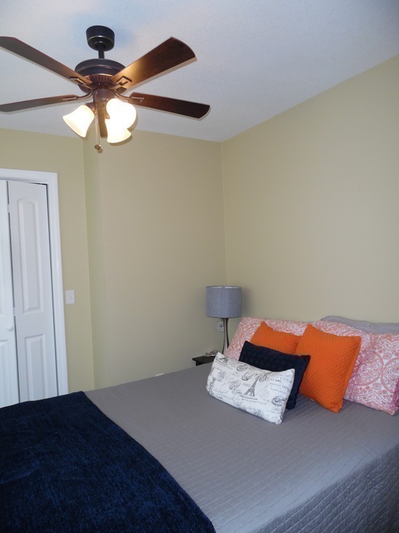 230 Russell Street Springfield, MA 01104 - Photo 7 of 18 a bedroom with a bed and a chandelier