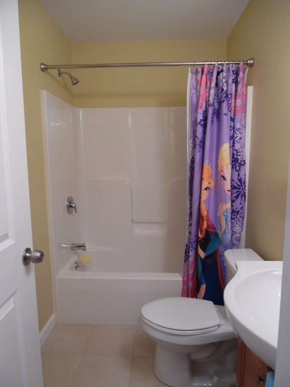230 Russell Street Springfield, MA 01104 - Photo 9 of 18 a white toilet sitting next to a bath tub