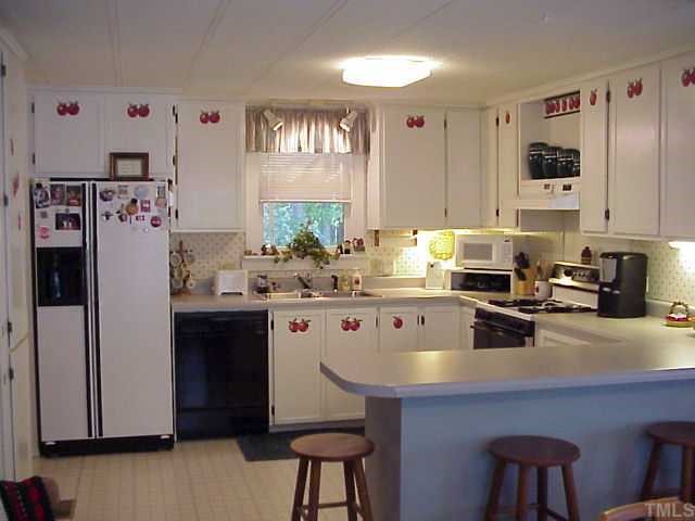 90 Pine Ridge Road Henderson, NC 27537 - Photo 3 of 11 Open kitchen with servicing counter, decorative cabinet doors; gas range, hood, dishwasher, microwave, dishposal,