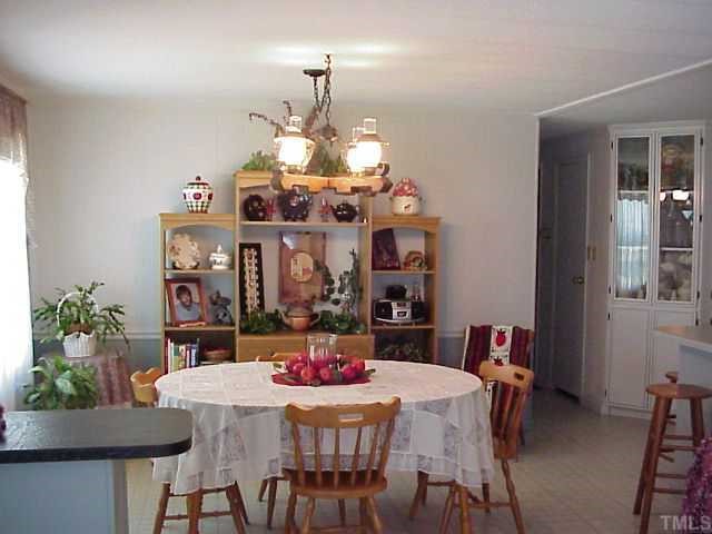 90 Pine Ridge Road Henderson, NC 27537 - Photo 4 of 11 Open diding area, built in corner cabinet where dining room and kitchen meets