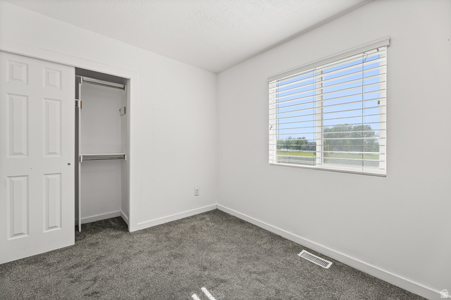 5525 Hampton Way Stansbury Park, UT 84074 - Photo 11 of 35 Room with white walls and grey carpet flooring