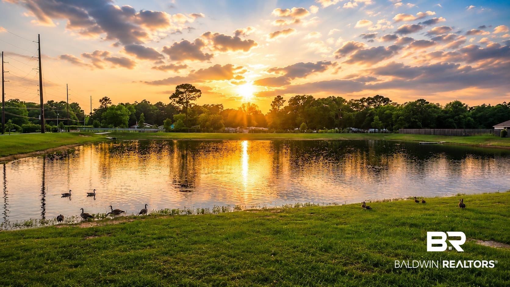12523 Pheasant Run Elberta, AL 36530 - Photo 5 of 43 Expansive pond with tranquil waters reflecting the sky, surrounded by lush green lawn
