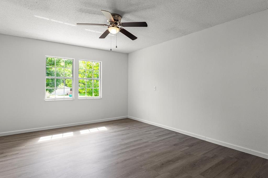 5700 South Calgary Terrace Inverness, FL 34452 - Photo 20 of 39 an empty room with wooden floor fan and windows