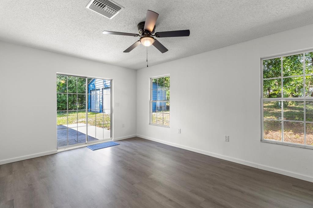 5700 South Calgary Terrace Inverness, FL 34452 - Photo 30 of 39 a view of an empty room with wooden floor and a window
