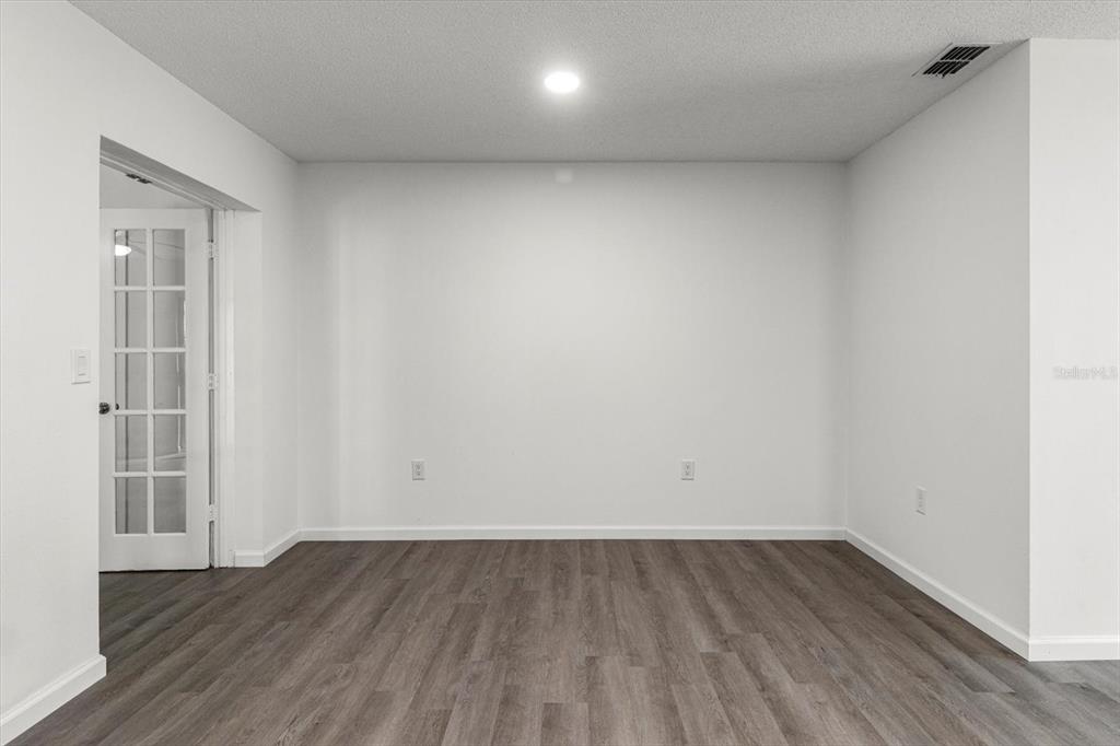 5700 South Calgary Terrace Inverness, FL 34452 - Photo 31 of 39 an empty room with wooden floor and windows