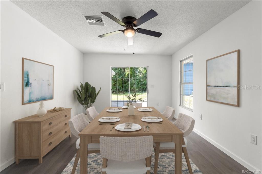 5700 South Calgary Terrace Inverness, FL 34452 - Photo 7 of 39 a view of a dining room with furniture window and wooden floor
