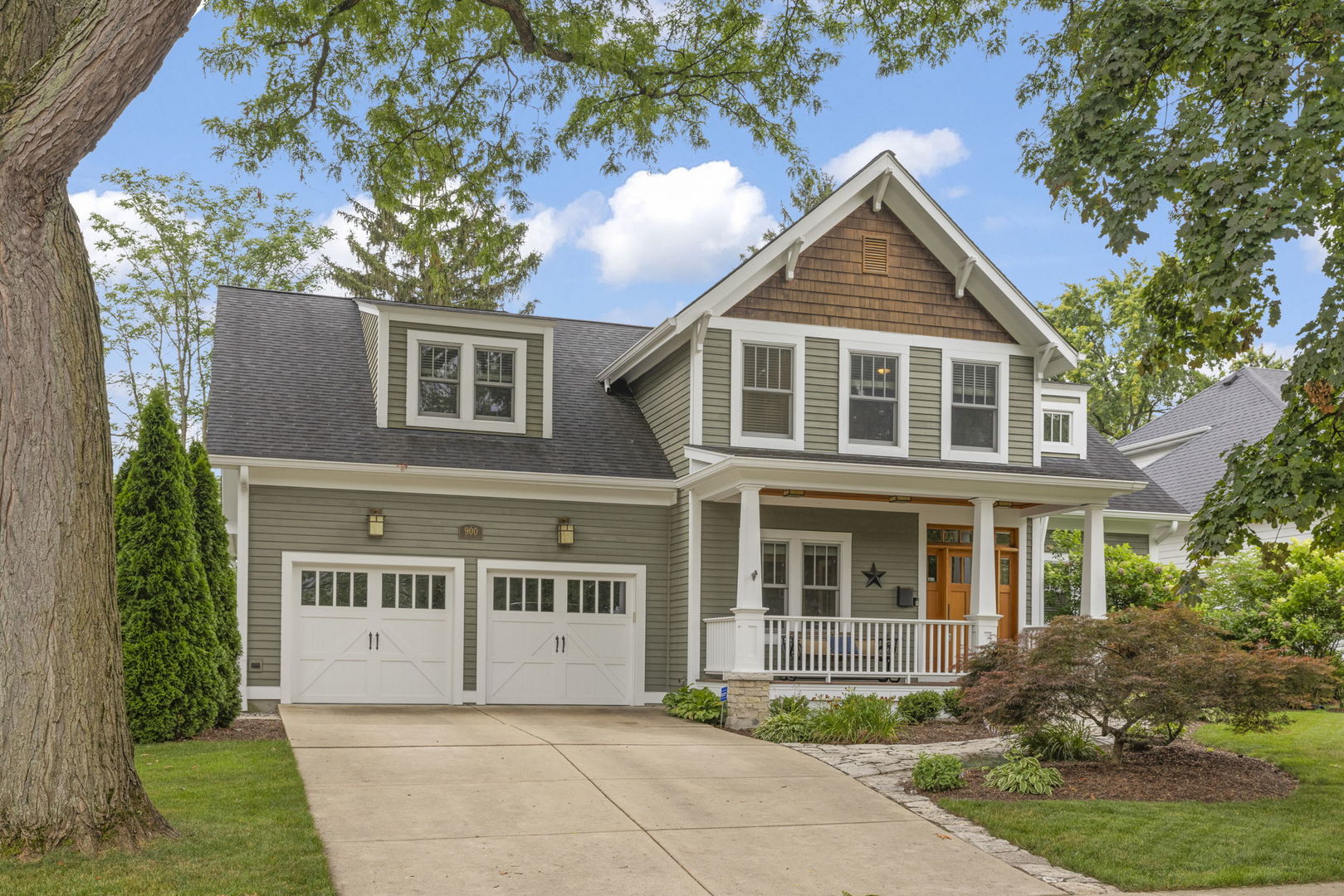 a front view of a house with a garden