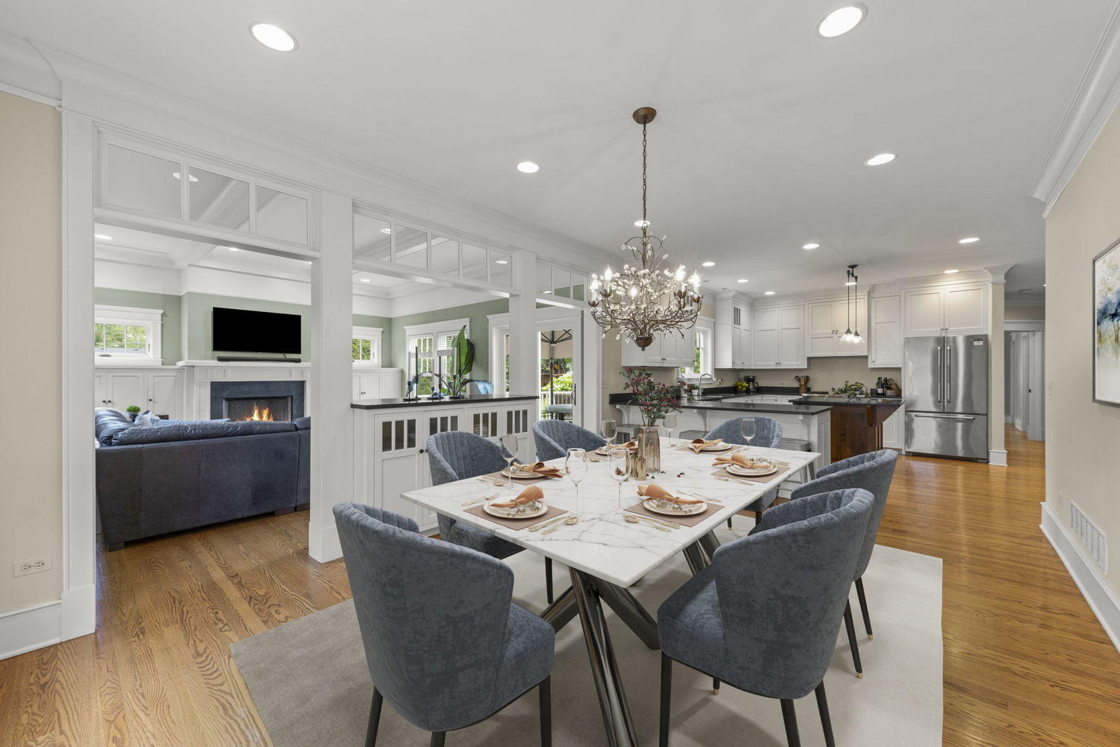 900 East Indiana Street Wheaton, IL 60187 - Photo 12 of 54 a view of a dining room and livingroom with furniture wooden floor a chandelier