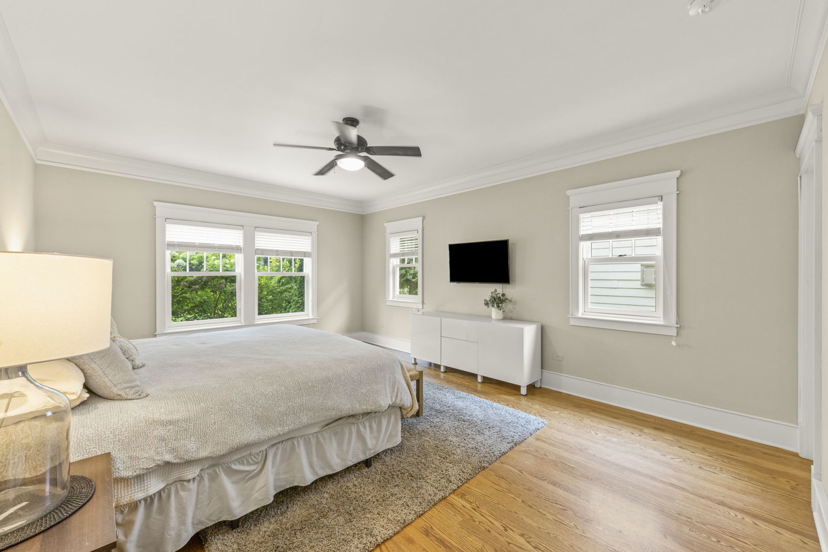 900 East Indiana Street Wheaton, IL 60187 - Photo 19 of 54 a spacious bedroom with a bed and a flat screen tv