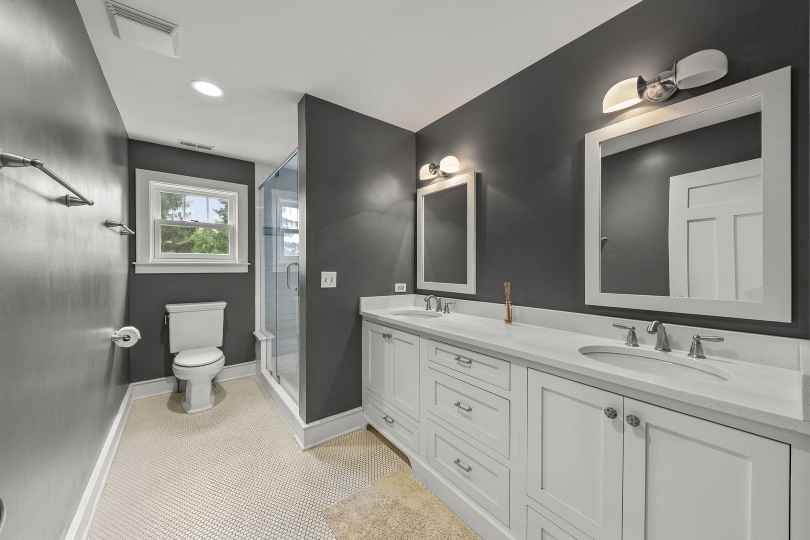 900 East Indiana Street Wheaton, IL 60187 - Photo 26 of 54 a spacious bathroom with a double vanity sink toilet and a mirror