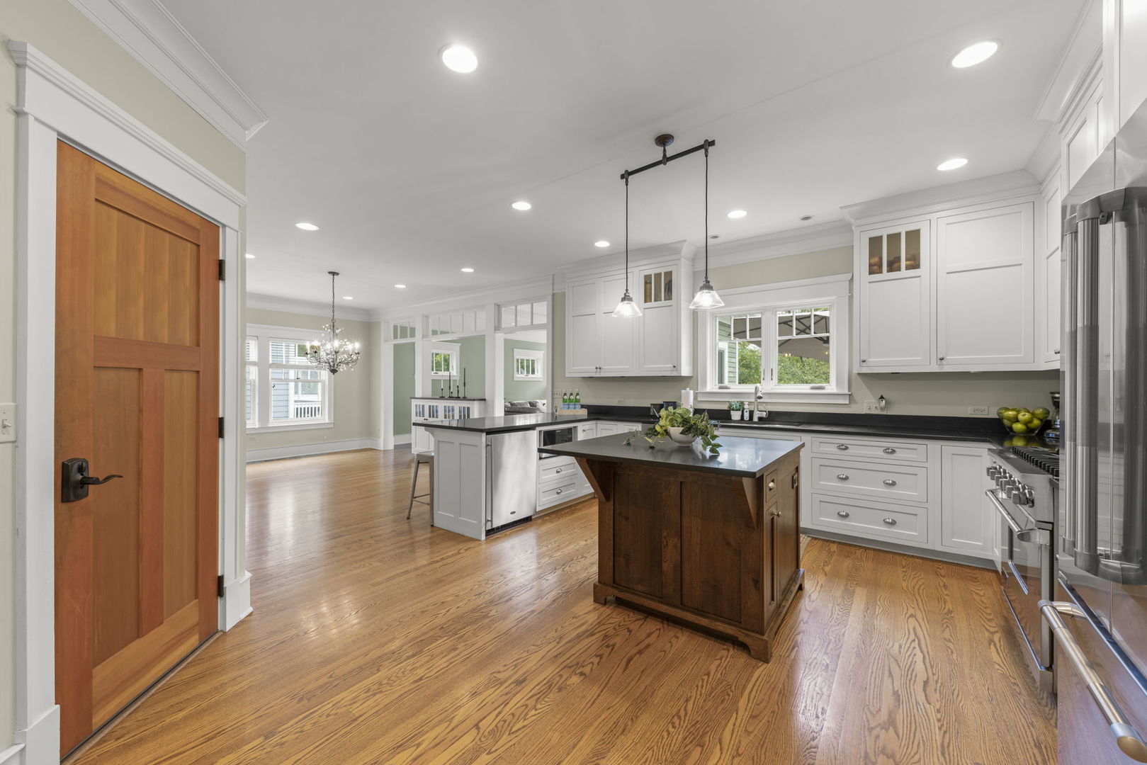 900 East Indiana Street Wheaton, IL 60187 - Photo 7 of 54 a kitchen with stainless steel appliances granite countertop wooden floors refrigerator and cabinets