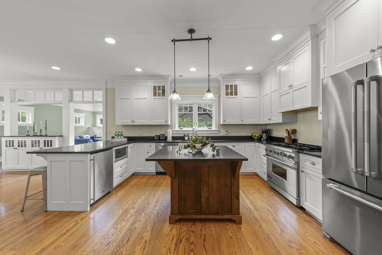 900 East Indiana Street Wheaton, IL 60187 - Photo 8 of 54 a kitchen with stainless steel appliances granite countertop wooden cabinets sink stove and refrigerator
