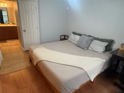 a large bed sitting in a bedroom next to a window