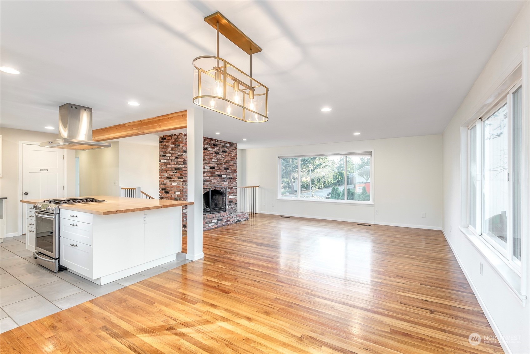 3016 Southwest 325th Place Federal Way, WA 98023 - Photo 11 of 40 a large kitchen with stainless steel appliances a large counter top a stove and a window