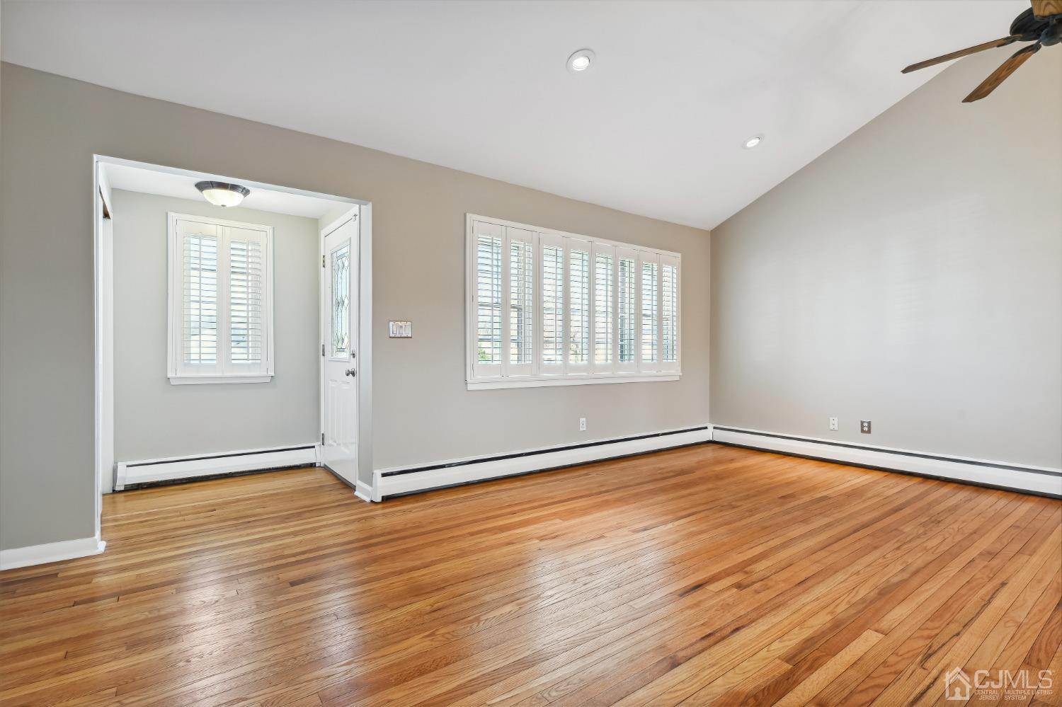 35 Miliken Road Colonia, NJ 07067 - Photo 4 of 23 an empty room with wooden floor and windows