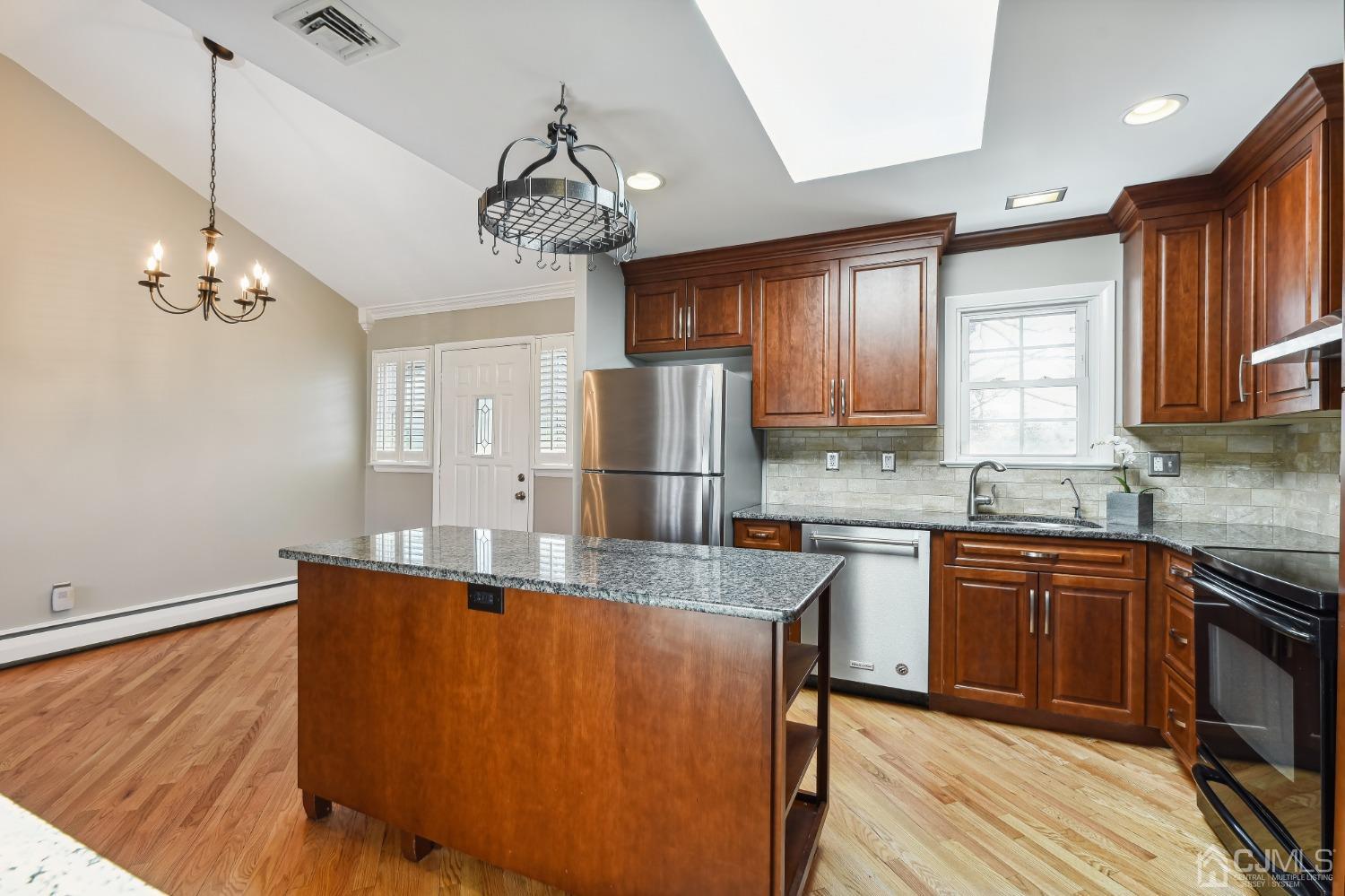 35 Miliken Road Colonia, NJ 07067 - Photo 8 of 23 a kitchen with stainless steel appliances granite countertop a sink refrigerator and cabinets