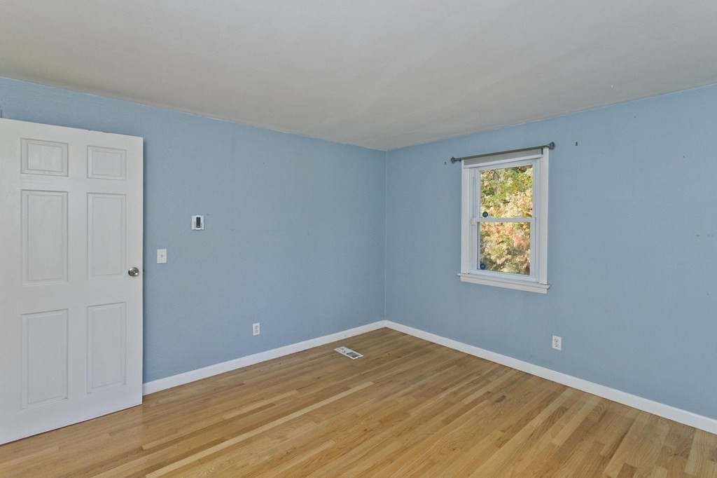 183 Peekskill Avenue Springfield, MA 01129 - Photo 15 of 31 a view of an empty room with wooden floor and a window