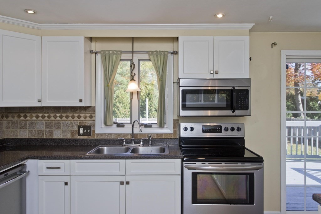 183 Peekskill Avenue Springfield, MA 01129 - Photo 4 of 31 a kitchen with a sink stove and microwave