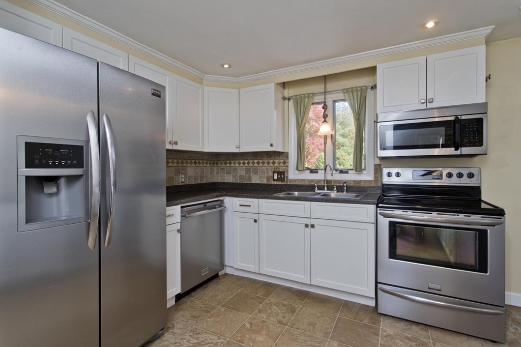 183 Peekskill Avenue Springfield, MA 01129 - Photo 5 of 31 a kitchen with cabinets stainless steel appliances and a window