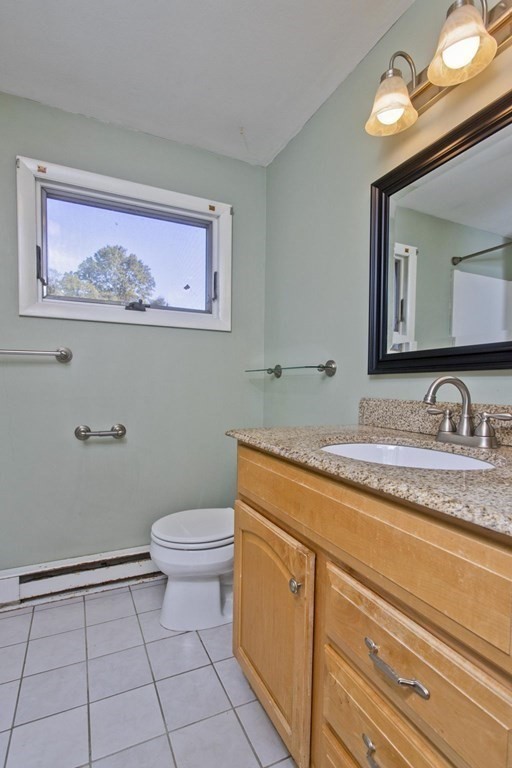 183 Peekskill Avenue Springfield, MA 01129 - Photo 8 of 31 a bathroom with a granite countertop toilet sink and mirror