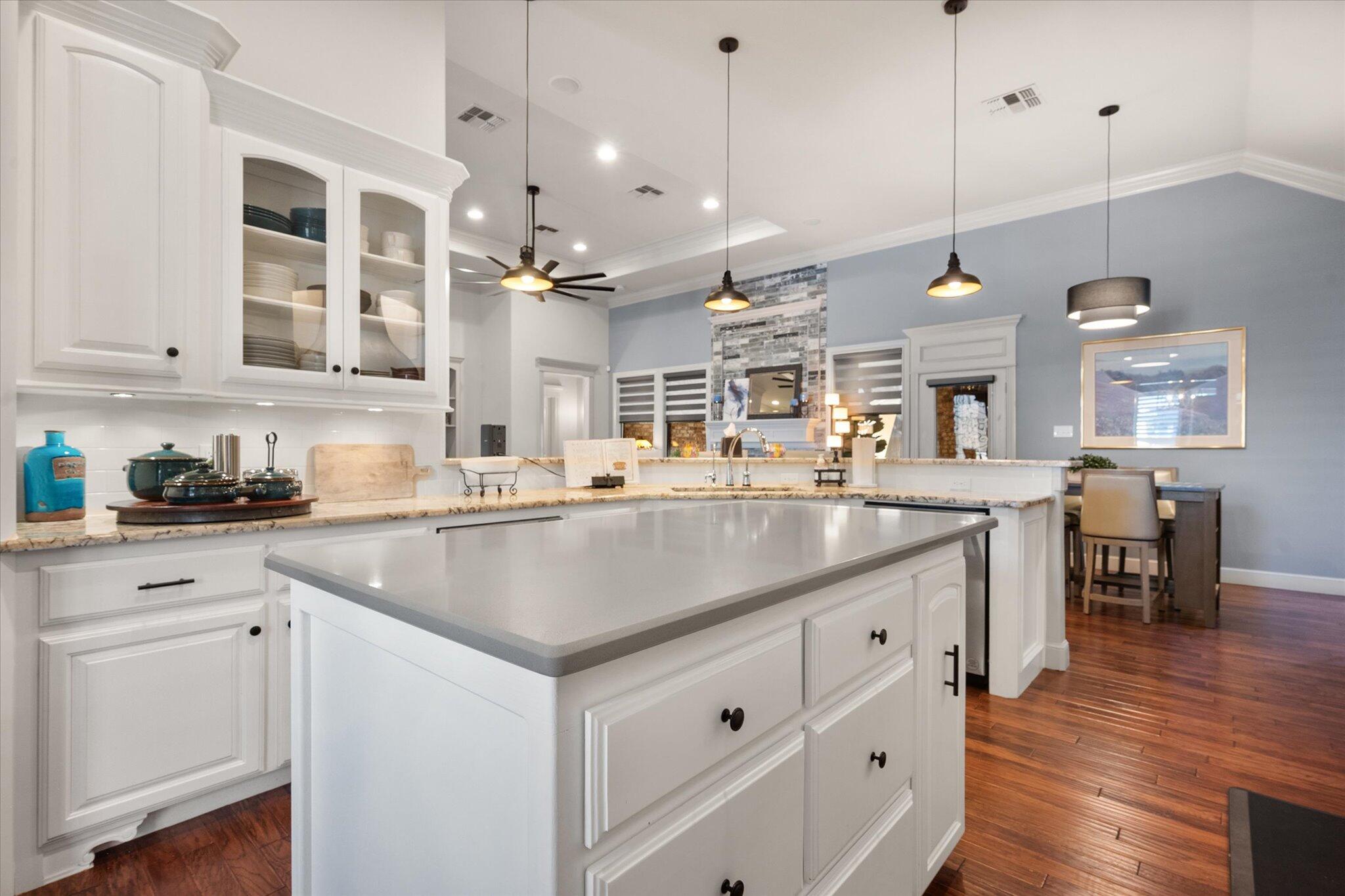 6021 89th Street Lubbock, TX 79424 - Photo 11 of 41 a kitchen with stainless steel appliances granite countertop a sink a stove and a wooden floors