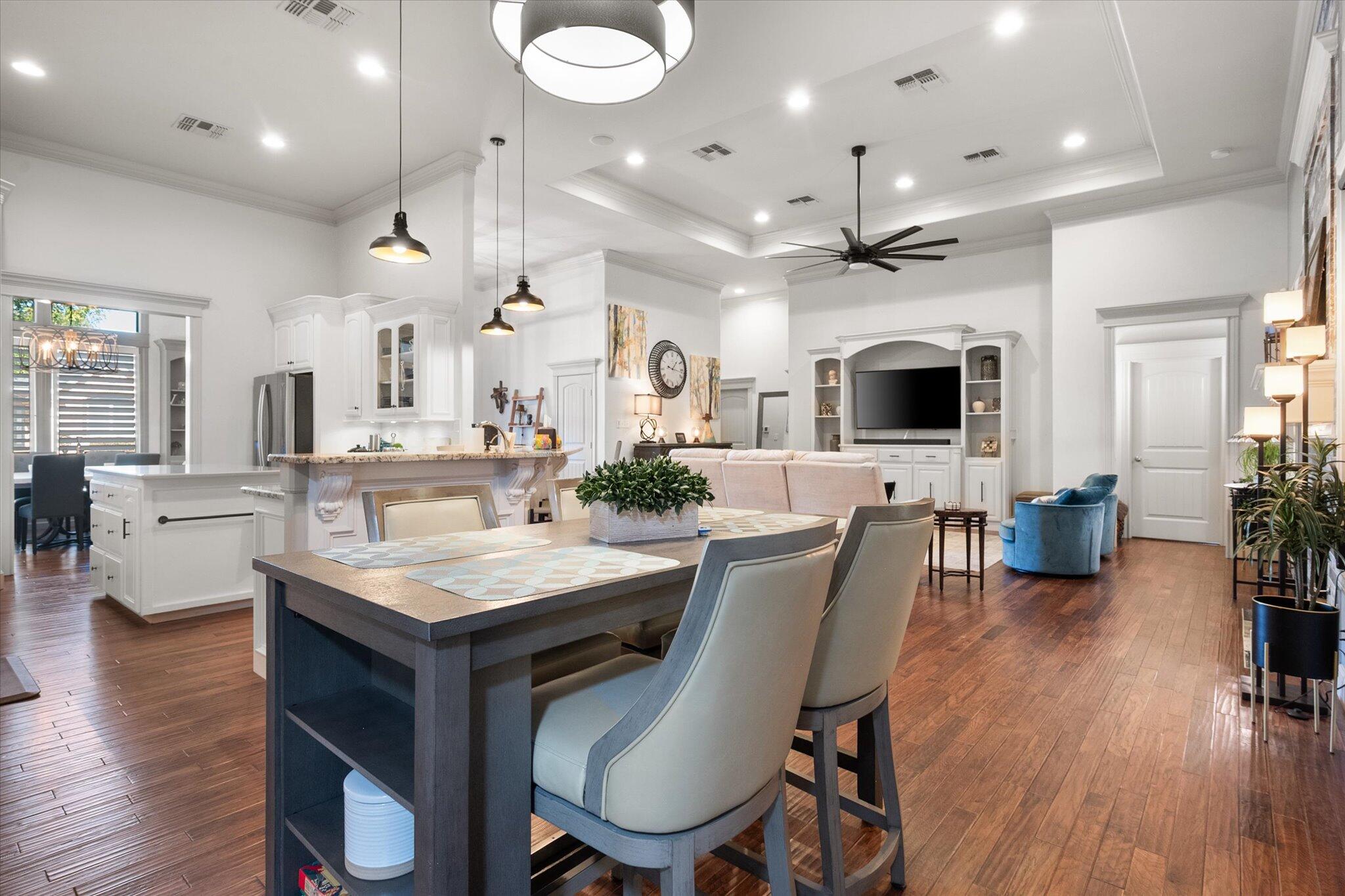 6021 89th Street Lubbock, TX 79424 - Photo 16 of 41 a view of a dining room with furniture wooden floor and chandelier