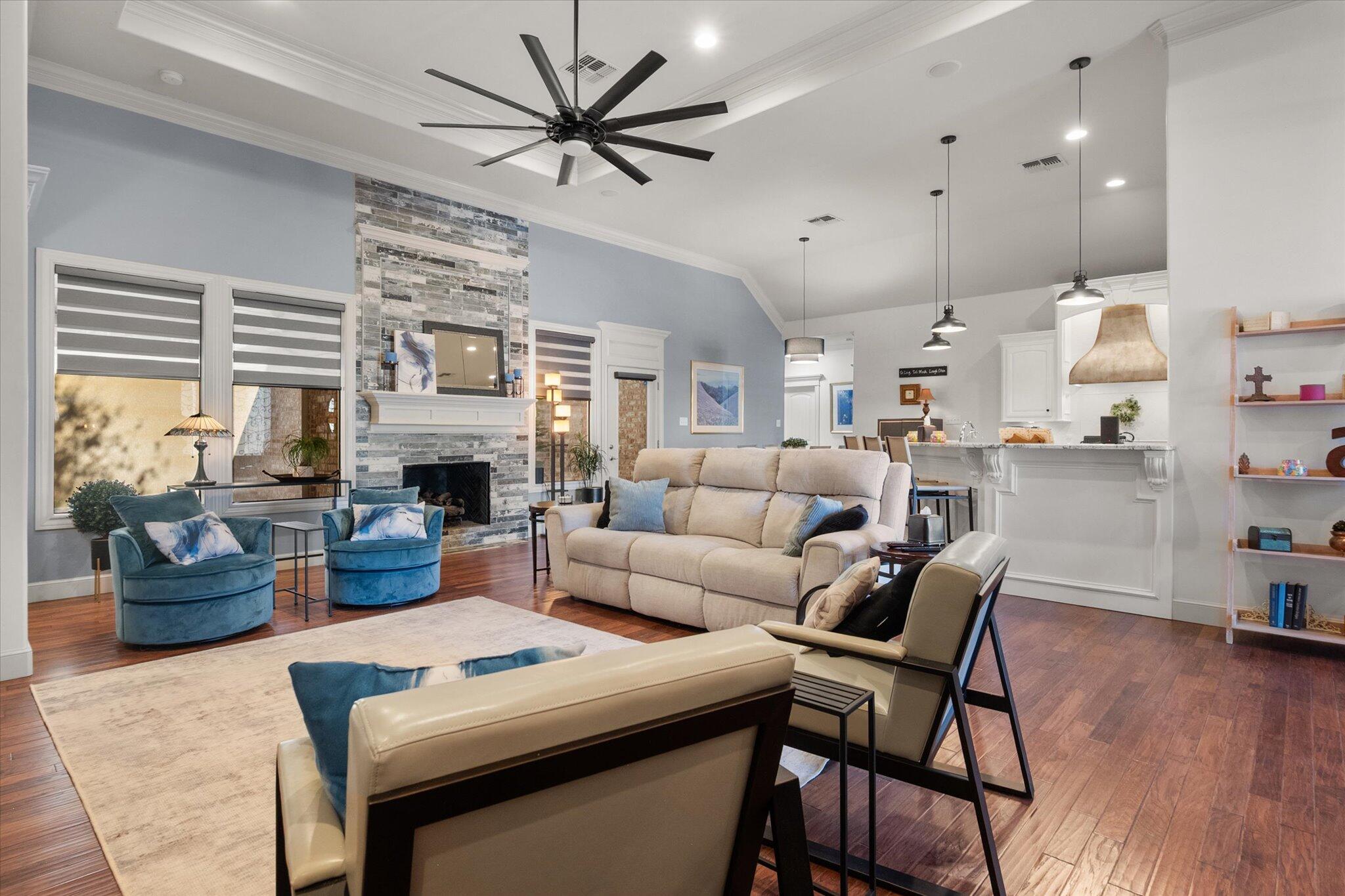 6021 89th Street Lubbock, TX 79424 - Photo 20 of 41 a living room with furniture a fireplace and a large window