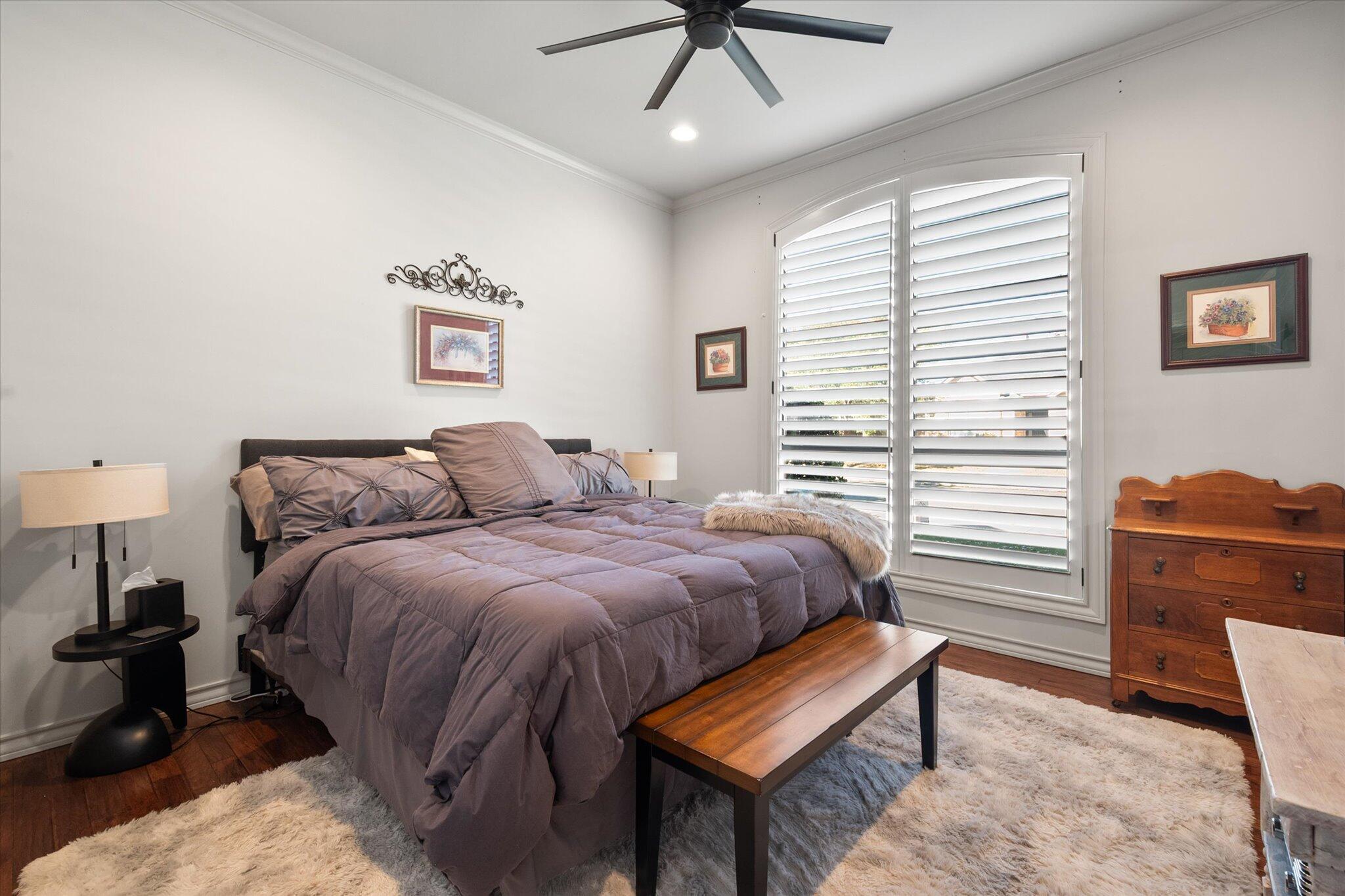 6021 89th Street Lubbock, TX 79424 - Photo 23 of 41 a bedroom with a bed and a chandelier