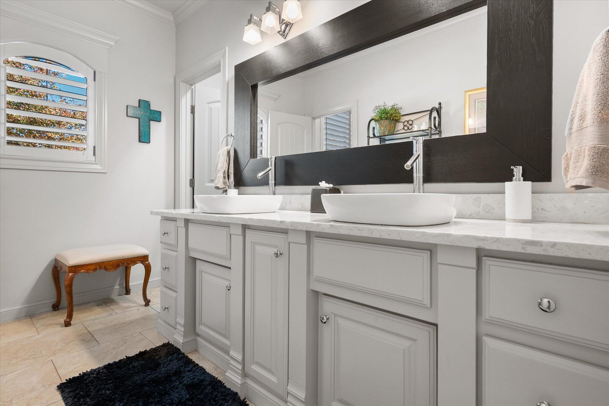 6021 89th Street Lubbock, TX 79424 - Photo 24 of 41 a bathroom with a sink and a mirror