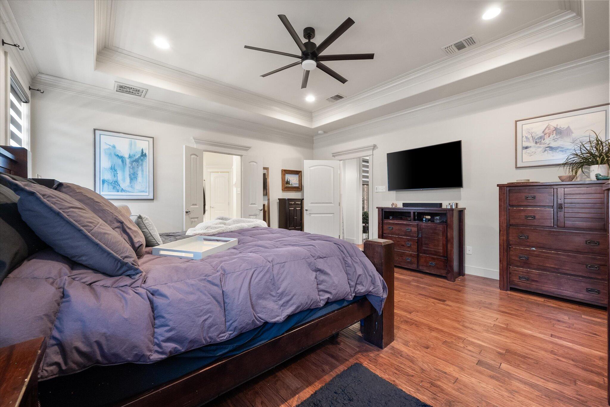 6021 89th Street Lubbock, TX 79424 - Photo 27 of 41 a bedroom with a bed and a flat screen tv