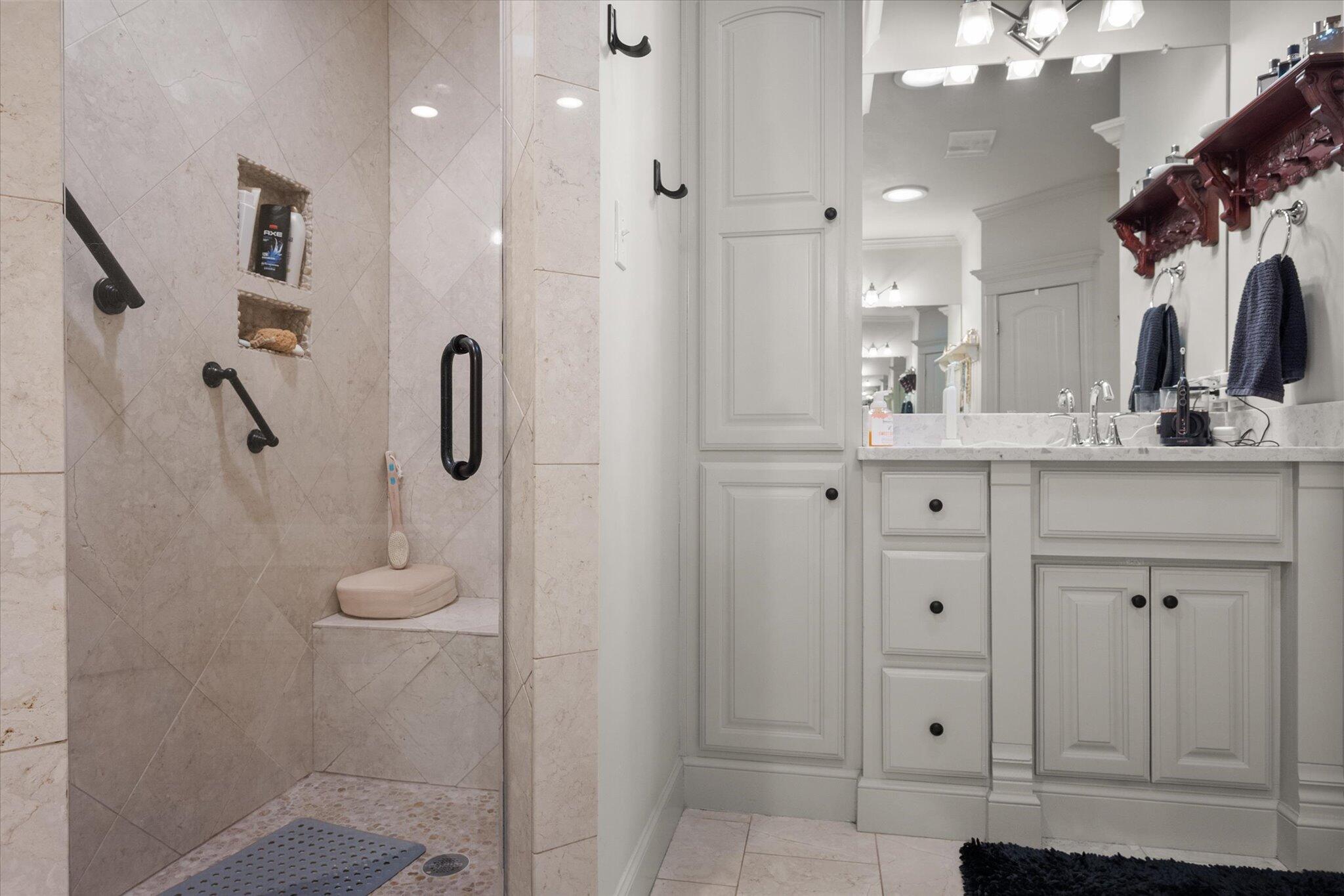 6021 89th Street Lubbock, TX 79424 - Photo 31 of 41 a bathroom with a double vanity sink mirror and shower