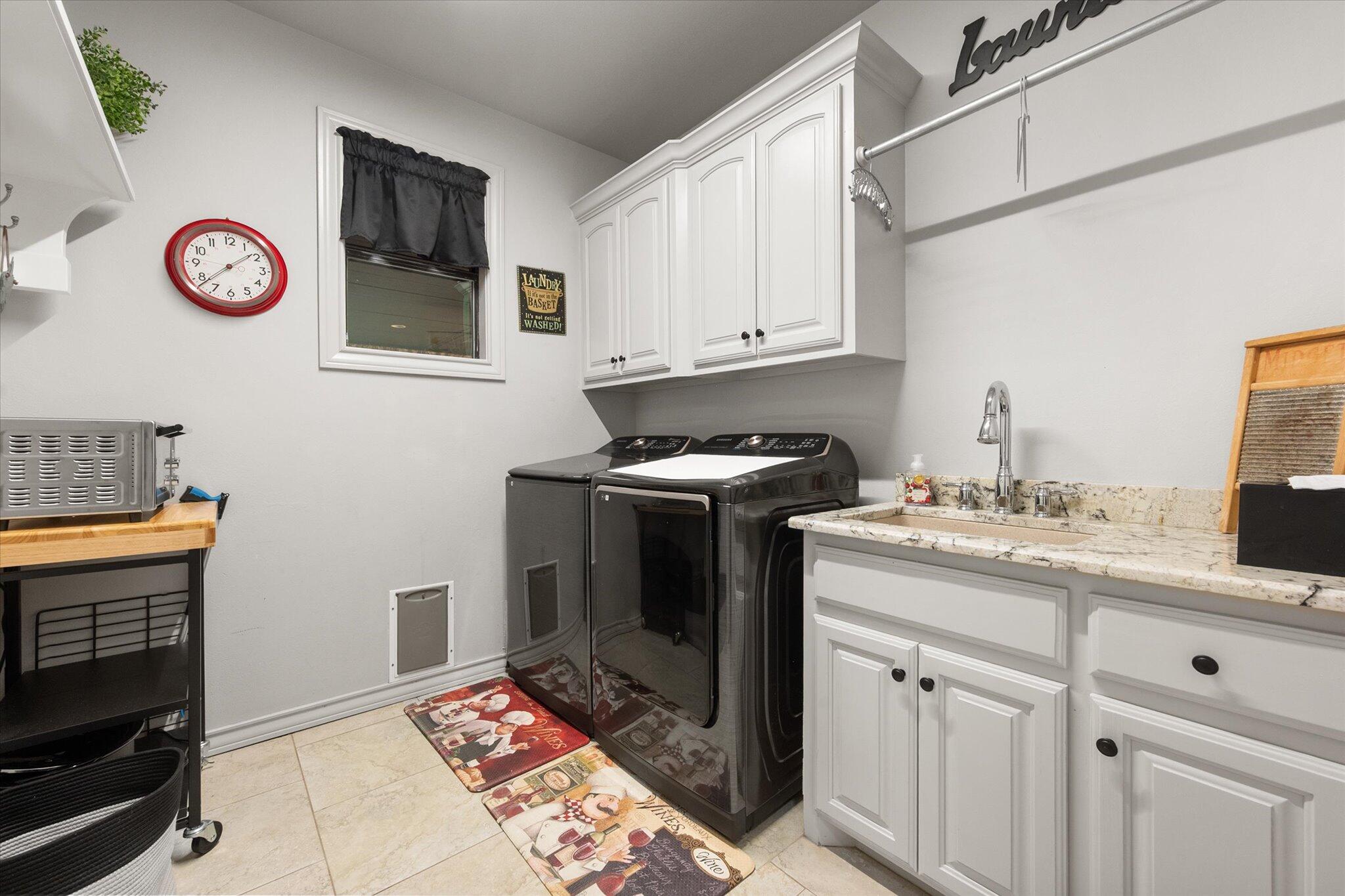 6021 89th Street Lubbock, TX 79424 - Photo 33 of 41 a kitchen with stainless steel appliances granite countertop a stove a sink and a microwave